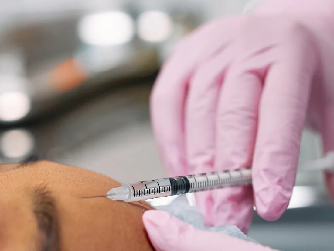 Injector treating forehead lines with a neuromodulator injection at LushRX Aesthetics