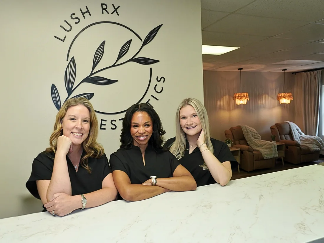 The LushRX Aesthetics team smiling at the front desk of the Leominster clinic