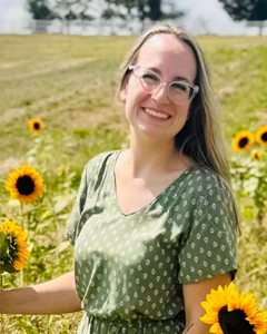 Client after GLP-1 weight loss treatment, standing in a sunflower field