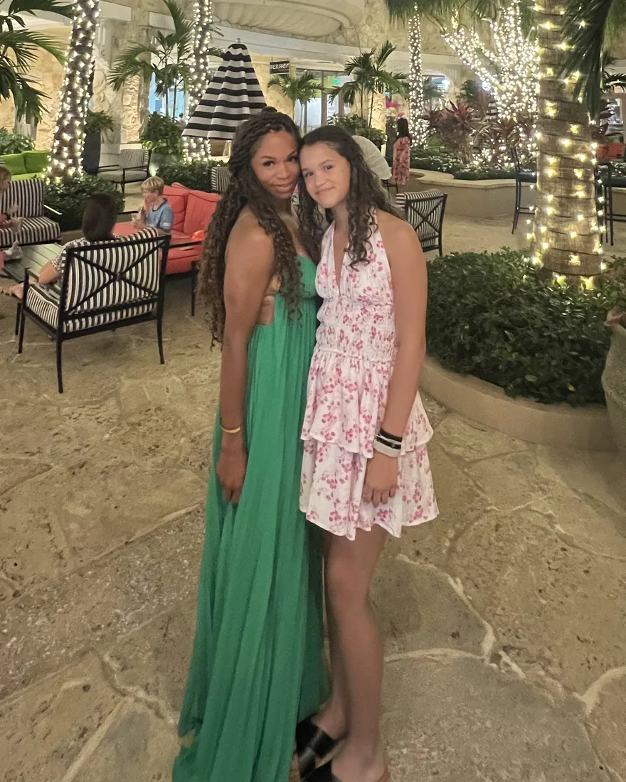Client after GLP-1 weight loss treatment, wearing a green dress